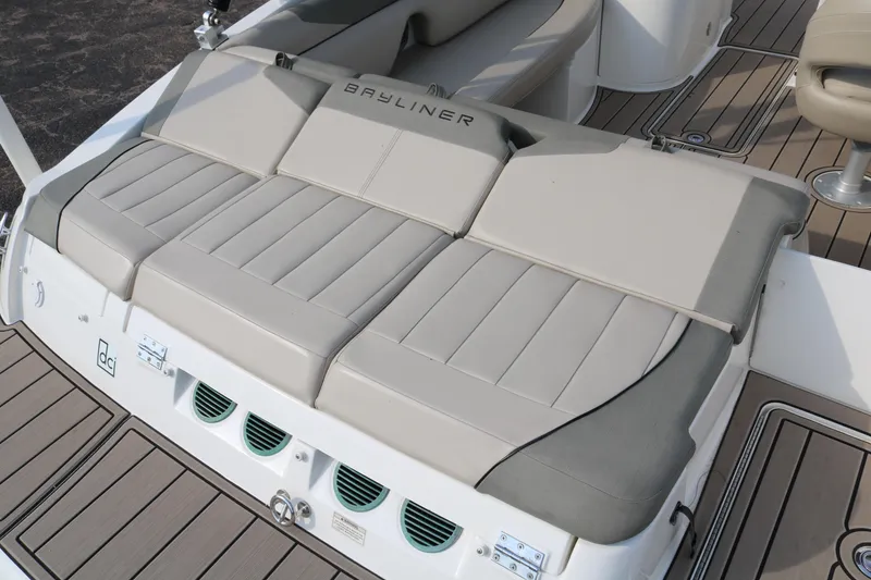 Slide: The Image of 2016 Bayliner 215 Deck Boat with beige seating and sleek design. - 11