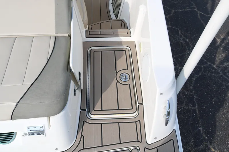 Slide: The Image of 2016 Bayliner 215 Deck Boat interior with cushioned seating and non-slip flooring. - 15