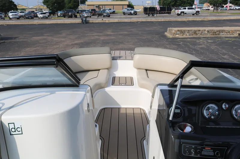 Slide: The Image of 2016 Bayliner 215 Deck Boat interior with seating and dashboard view. - 18