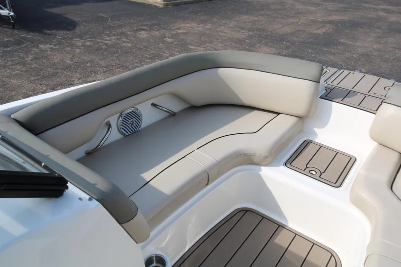 Slide: The Image of 2016 Bayliner 215 Deck Boat interior with cushioned seating and speaker. - 19
