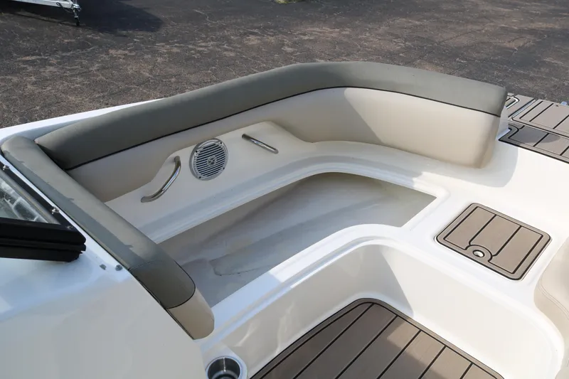 Slide: The Image of 2016 Bayliner 215 Deck Boat interior seating with speaker and storage compartments. - 20