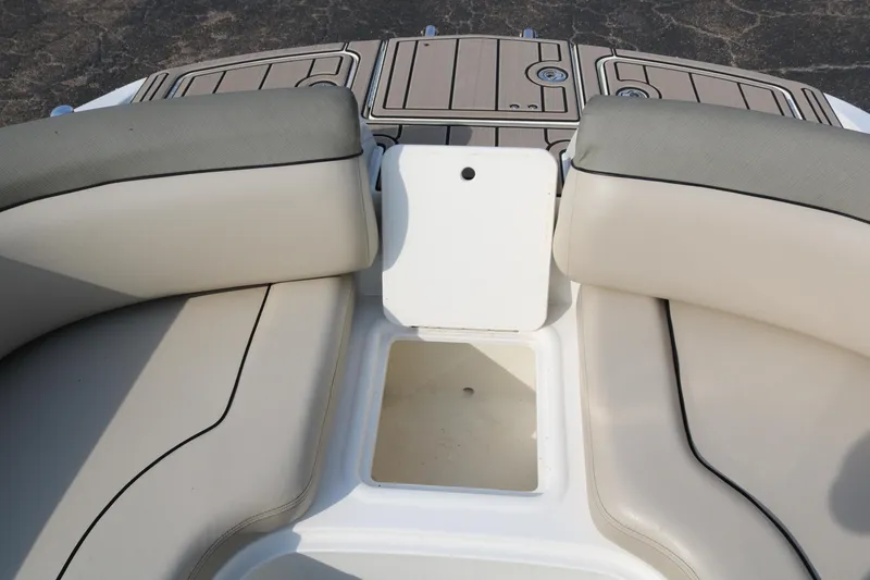 Slide: The Image of 2016 Bayliner 215 Deck Boat interior seating with storage compartment. - 24