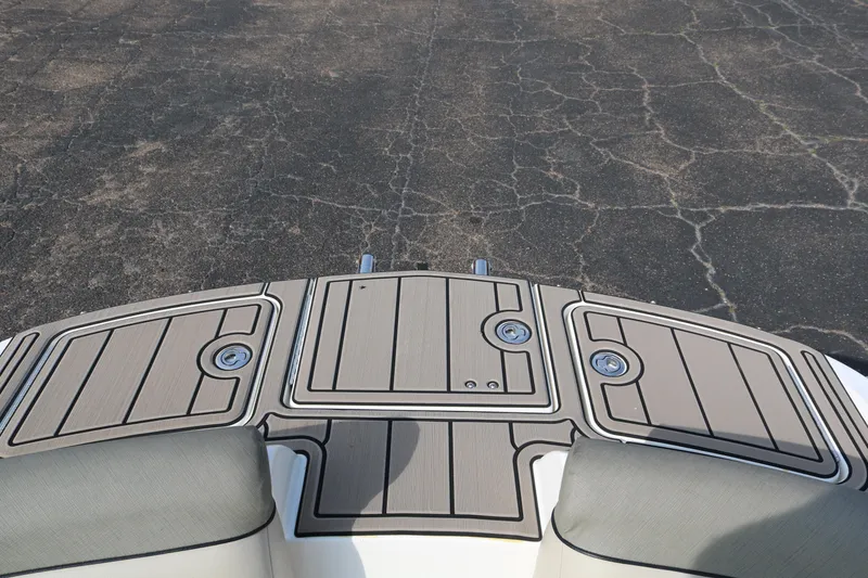 Slide: The Image of 2016 Bayliner 215 Deck Boat swim platform with textured surface and storage compartments. - 25