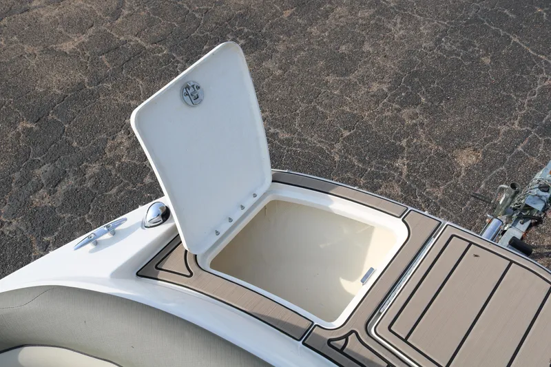 Slide: The Image of Open storage compartment on 2016 Bayliner 215 Deck Boat, featuring sleek design and functionality. - 26