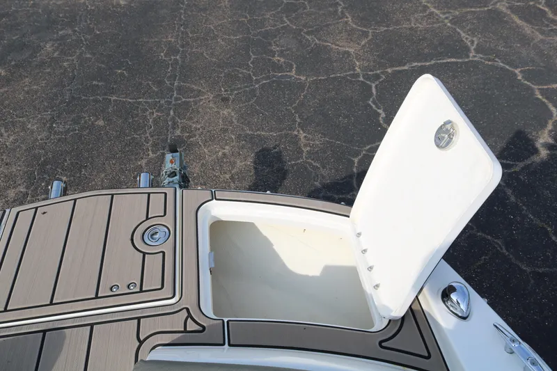 Slide: The Image of 2016 Bayliner 215 Deck Boat with open storage compartment on deck. - 28