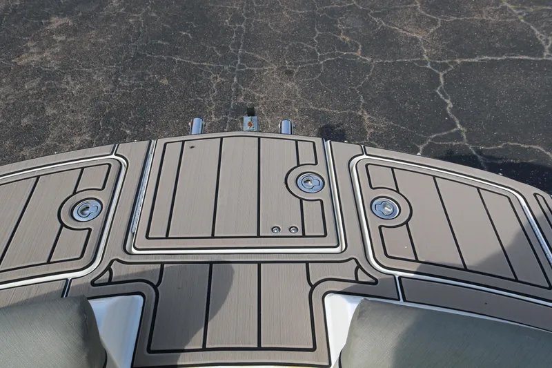 Slide: The Image of 2016 Bayliner 215 Deck Boat swim platform with textured surface and storage compartments. - 29