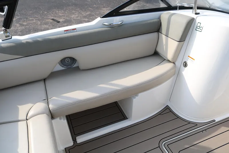 Slide: The Image of 2016 Bayliner 215 Deck Boat interior with beige seating and sleek design. - 35
