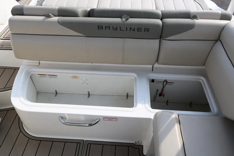 Slide: The Image of 2016 Bayliner 215 Deck Boat interior storage compartments and seating area. - 38