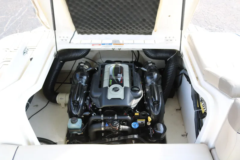 Slide: The Image of 2016 Bayliner 215 Deck Boat engine compartment, showcasing a clean and well-maintained motor. - 39