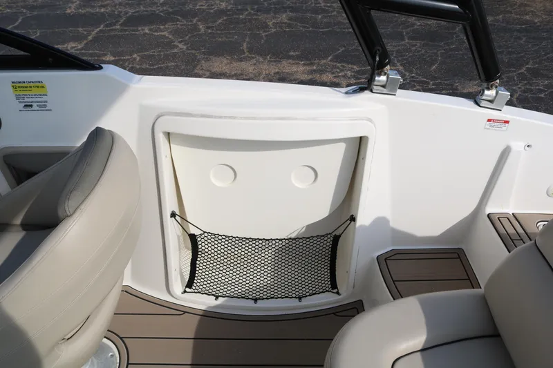 Slide: The Image of 2016 Bayliner 215 Deck Boat interior with seating and storage compartment. - 40
