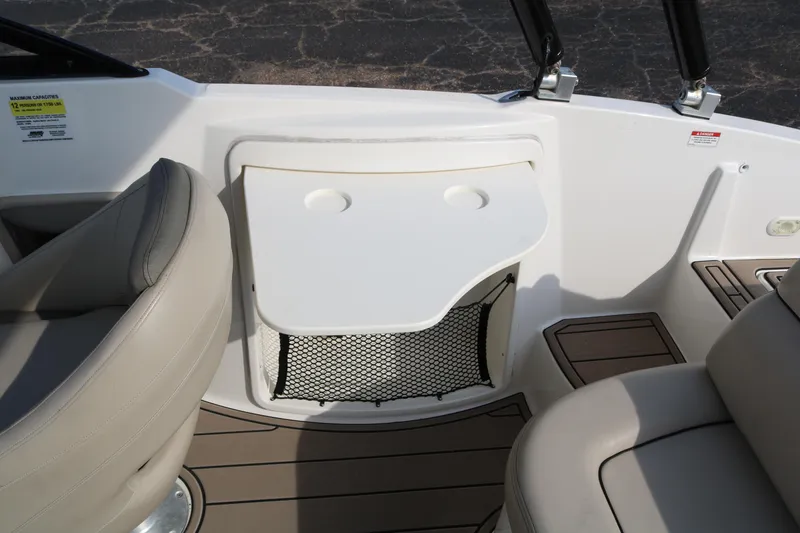 Slide: The Image of 2016 Bayliner 215 Deck Boat interior with seating and storage compartment. - 41