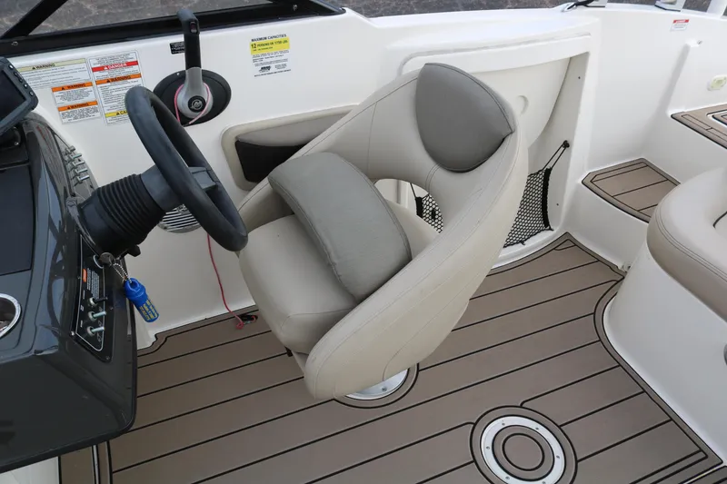 Slide: The Image of Captain's seat and steering wheel of 2016 Bayliner 215 Deck Boat, featuring modern design. - 44