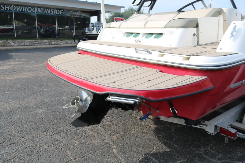Slide: The Image of 2016 Bayliner 215 Deck Boat rear view with propeller and swim platform. - 8