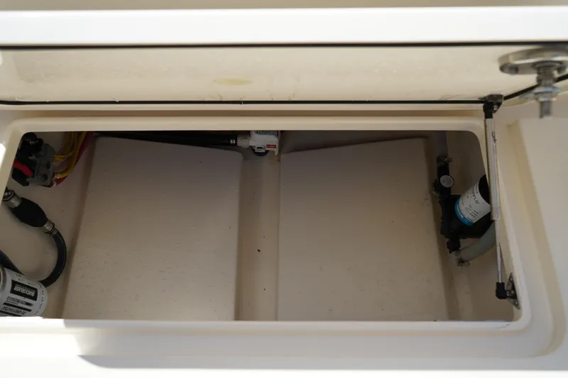 Slide: The Image of Storage compartment of 2022 Scout 215 XSF boat, showing interior details and components. - 11