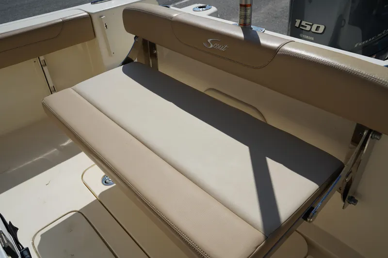 Slide: The Image of 2022 Scout 215 XSF boat with beige seating and 150 horsepower engine. - 12