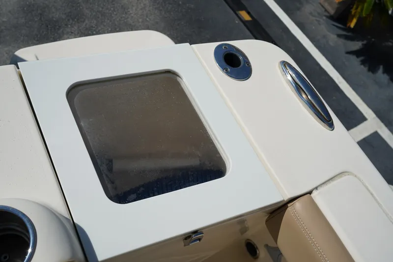 Slide: The Image of 2022 Scout 215 XSF boat detail with storage compartment and cup holders. - 13