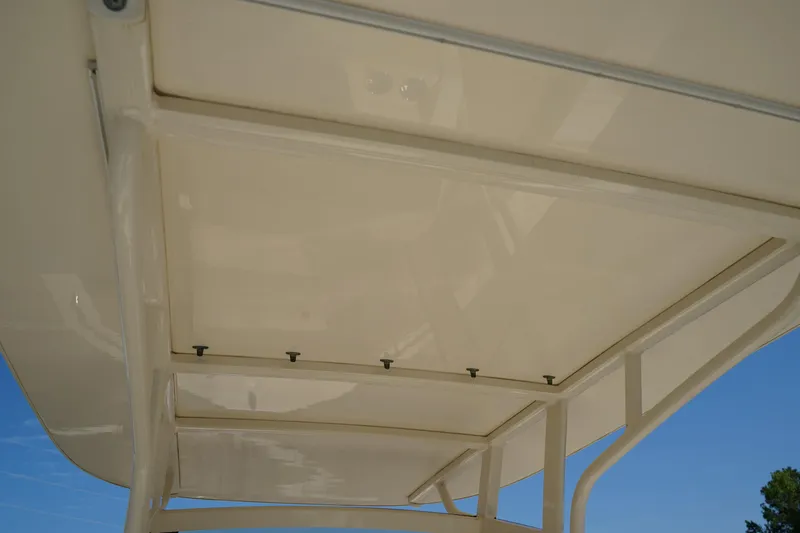 Slide: The Image of 2022 Scout 215 XSF boat canopy, beige color, viewed from below against blue sky. - 18