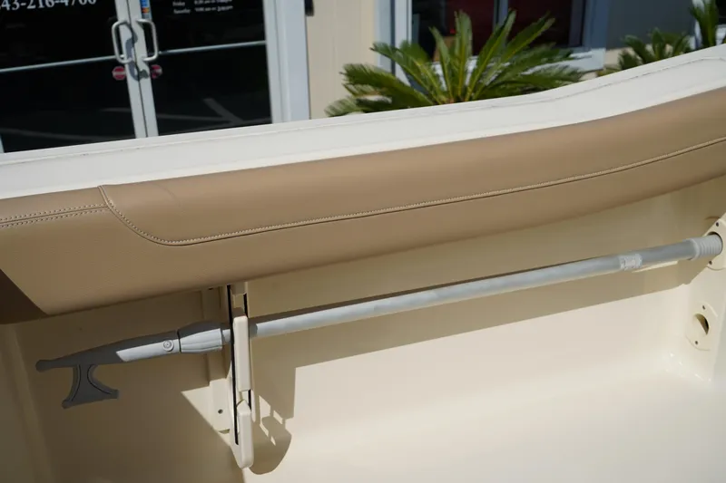 Slide: The Image of 2022 Scout 215 XSF boat interior with beige seating and mounted rod holder. - 19