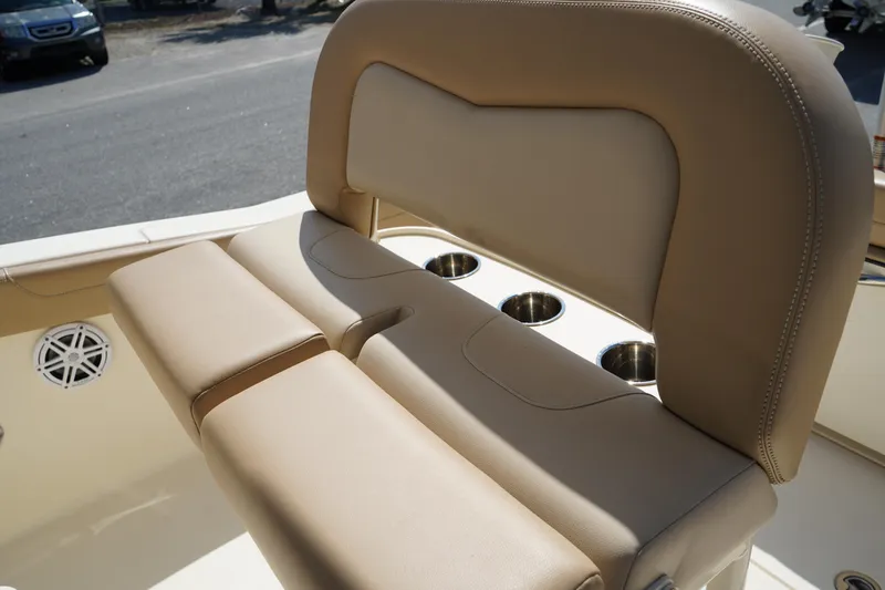 Slide: The Image of 2022 Scout 215 XSF boat seating with cup holders and beige upholstery. - 22