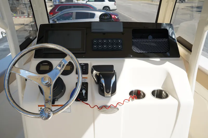 Slide: The Image of 2022 Scout 215 XSF boat dashboard with steering wheel and control panel. - 23
