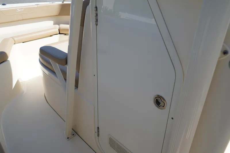 Slide: The Image of 2022 Scout 215 XSF boat interior with seating and storage compartment. - 30