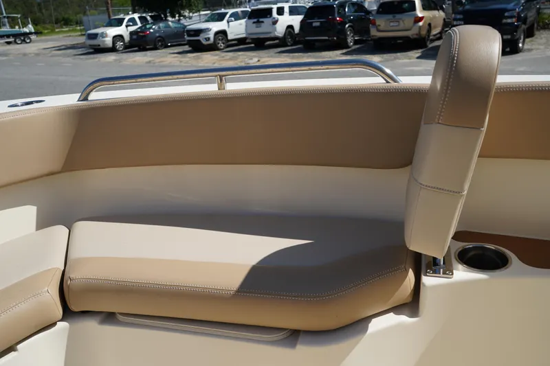 Slide: The Image of 2022 Scout 215 XSF boat interior with beige seating and cup holder. - 35