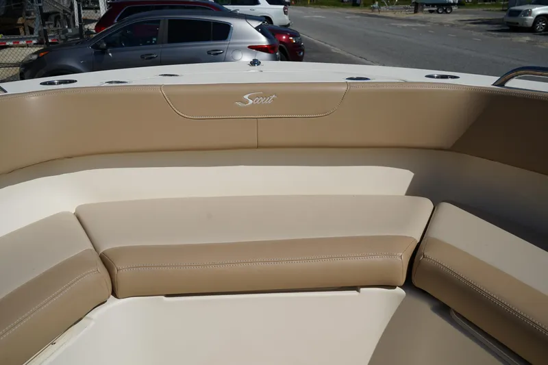 Slide: The Image of 2022 Scout 215 XSF boat interior with beige seating and logo. - 38