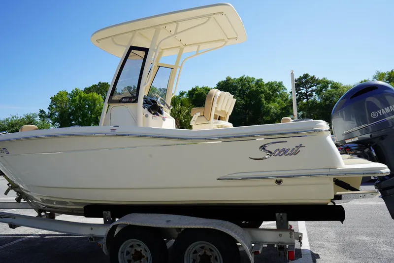 Slide: The Image of 2022 Scout 215 XSF boat on trailer, side view, outdoors, clear sky. - 5