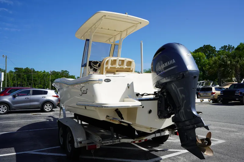 Slide: The Image of 2022 Scout 215 XSF boat on trailer with Yamaha outboard motor in parking lot. - 6