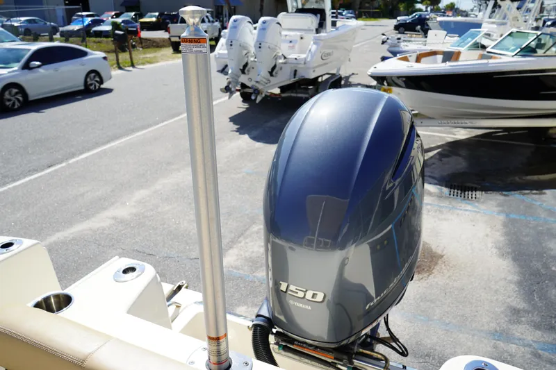 Slide: The Image of 2022 Scout 215 XSF boat with Yamaha 150 engine in a marina setting. - 9