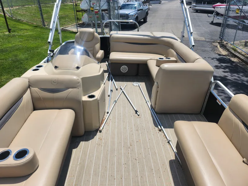 Slide: The Image of Pontoon boat interior with beige seating, Sweetwater 2086 C, 2018 model, parked on a sunny day. - 10