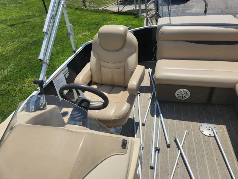 Slide: The Image of 2018 Sweetwater 2086 C boat interior with beige seating and steering wheel. - 12
