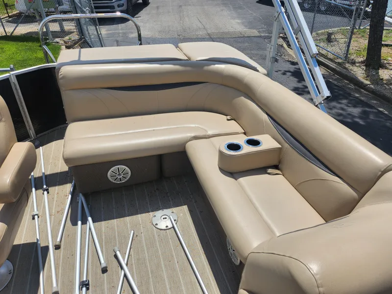 Slide: The Image of 2018 Sweetwater 2086 C pontoon boat interior with beige seating and cup holders. - 13