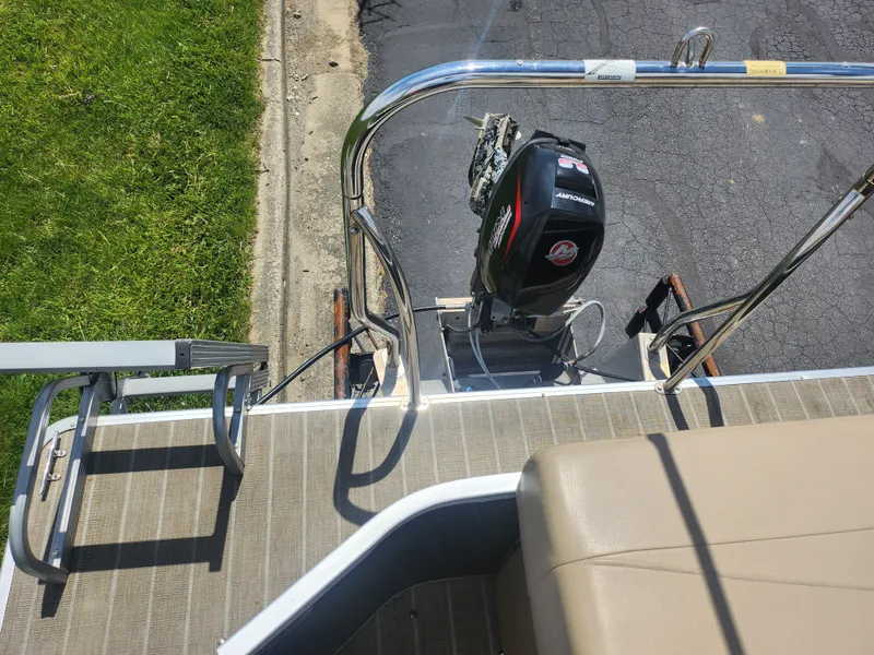 Slide: The Image of 2018 Sweetwater 2086 C boat with motor, docked on a sunny day. - 16