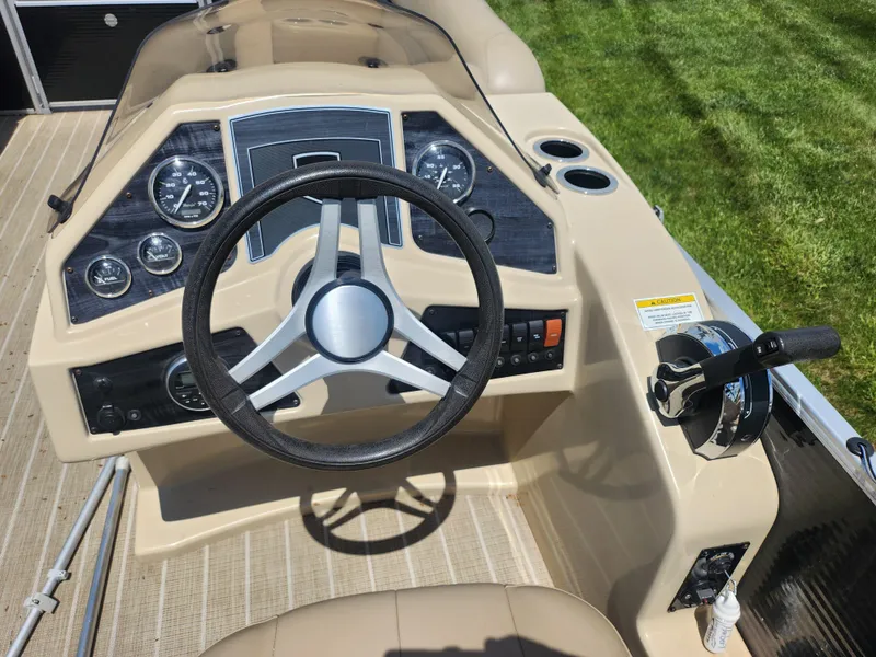Slide: The Image of Steering console of a 2018 Sweetwater 2086 C boat, featuring gauges and controls. - 19