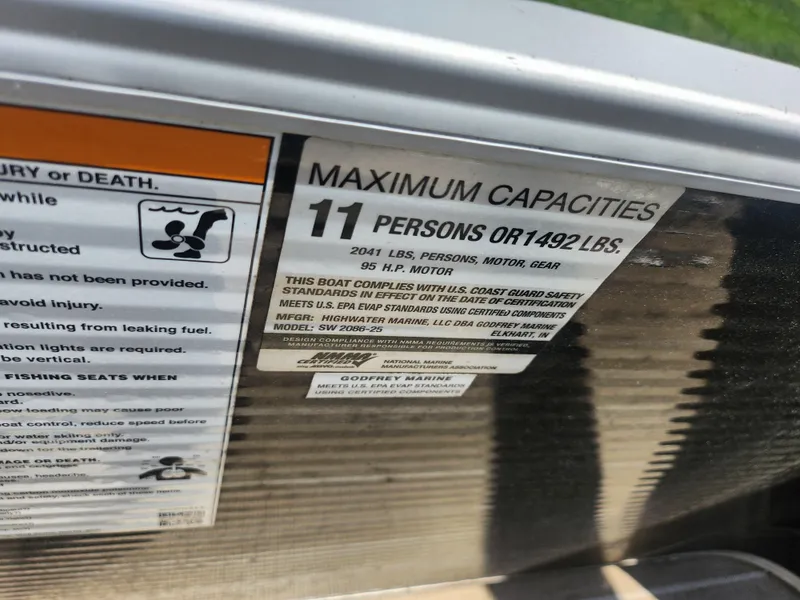 Slide: The Image of Sweetwater 2086 C 2018 boat capacity label, max 11 persons or 1492 lbs, 55 HP motor. - 20