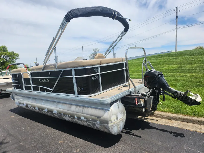 Slide: The Image of 2018 Sweetwater 2086 C pontoon boat with canopy and outboard motor on a sunny day. - 3