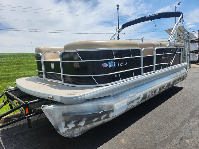 Slide: The Image of 2018 Sweetwater 2086 C pontoon boat on trailer, parked outdoors under a clear sky. - 5