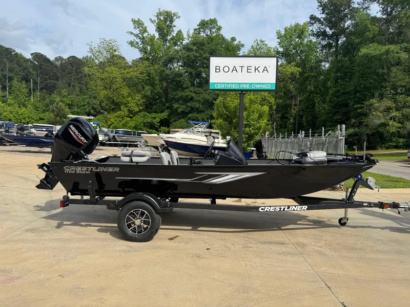 Slide: The Image of 2025 Crestliner 1700 Storm boat on trailer at Boateka dealership. - 2