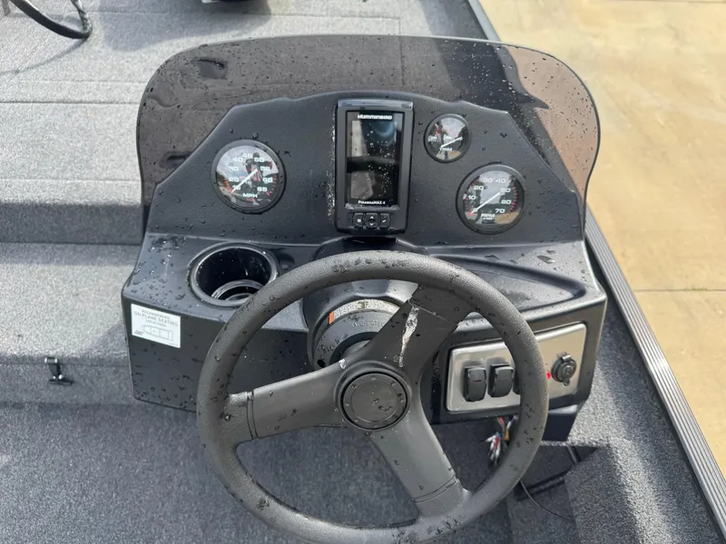 Slide: The Image of 2025 Crestliner 1700 Storm boat dashboard with steering wheel and gauges. - 7