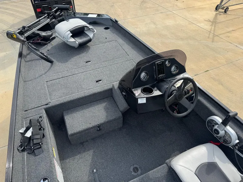 Slide: The Image of 2025 Crestliner 1700 Storm boat interior with steering console and seating. - 8