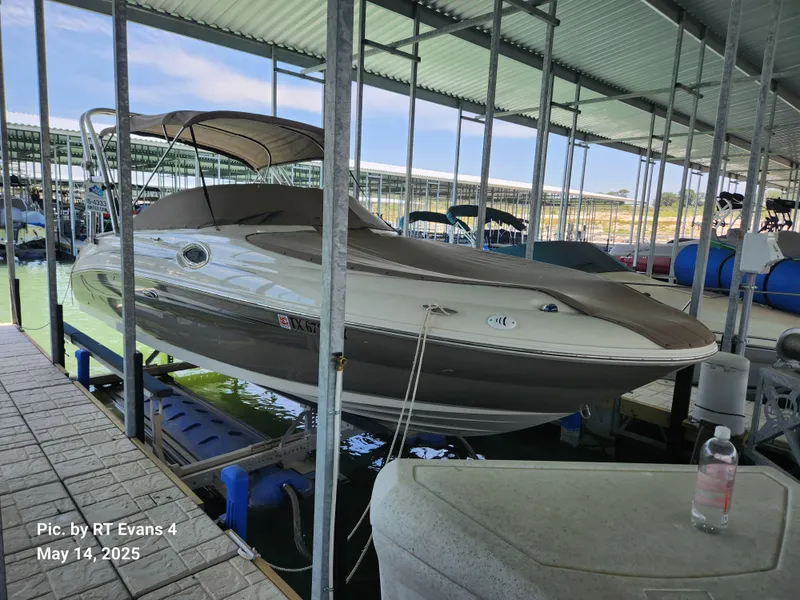 Slide: The Image of 2008 Sea Ray 240 Sundeck boat docked in a covered marina. - 0