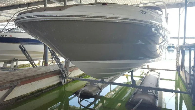 Slide: The Image of 2008 Sea Ray 240 Sundeck boat docked in a covered marina. - 1