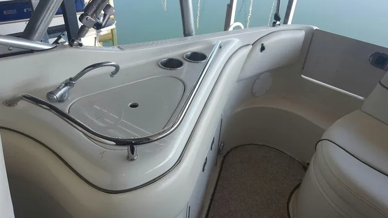 Slide: The Image of 2008 Sea Ray 240 Sundeck interior with sink and seating area. - 13
