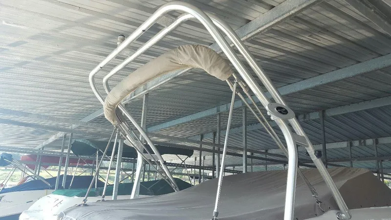 Slide: The Image of 2008 Sea Ray 240 Sundeck with covered bimini top in marina storage. - 16