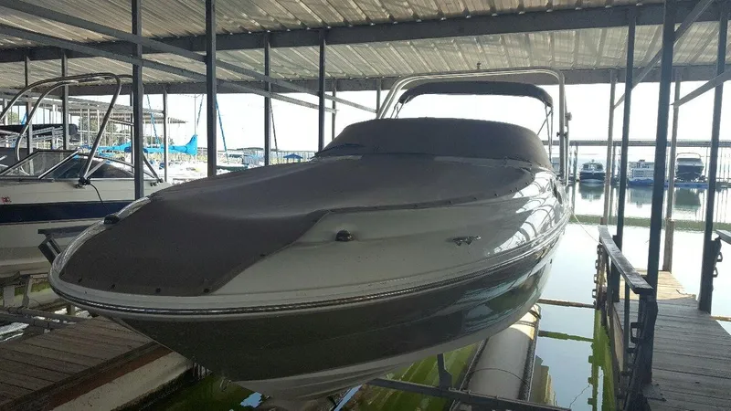 Slide: The Image of 2008 Sea Ray 240 Sundeck boat docked under a covered marina. - 17