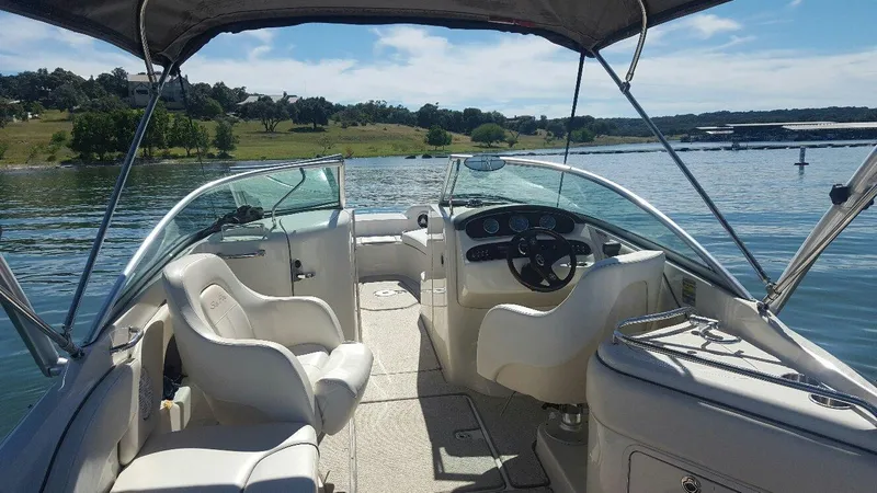 Slide: The Image of 2008 Sea Ray 240 Sundeck boat interior with seating, steering wheel, and lake view. - 3
