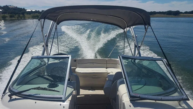 Slide: The Image of 2008 Sea Ray 240 Sundeck cruising on a sunny lake, creating a wake behind. - 5