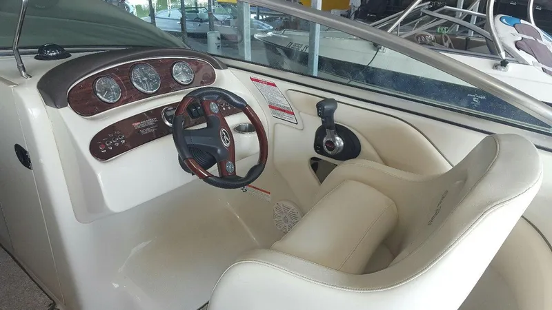 Slide: The Image of 2008 Sea Ray 240 Sundeck boat cockpit with steering wheel and gauges. - 7