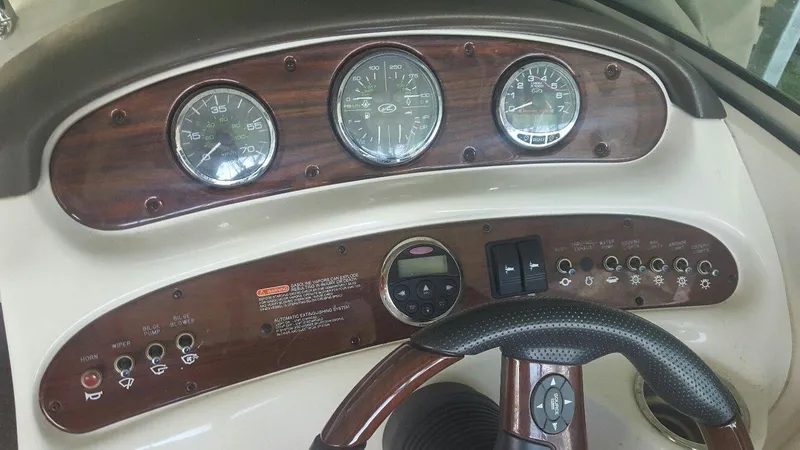 Slide: The Image of Dashboard of a 2008 Sea Ray 240 Sundeck boat with gauges and controls. - 8